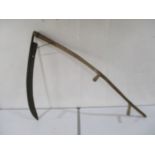 A large vintage wooden handled scythe