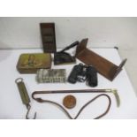 A collection of various interesting items including a paper embosser, Swift Saratoga binoculars,