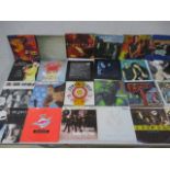 A collection of 7" vinyl records & several picture discs including Bruce Stringsteen, Madonna, Joy