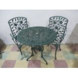 A metal garden table, along with two matching chairs