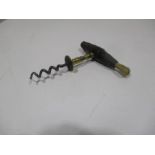 A vintage corkscrew with brush