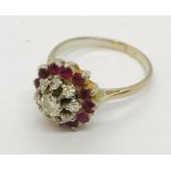 An18ct gold diamond and ruby cluster ring with a row of diamonds and another of rubies around a