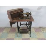 A 20th century Singer sewing machine, on Singer treadle stand with mesh work foot pedal