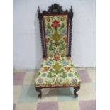 A Victorian carved walnut high back chair with barley twist decoration
