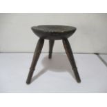 A rustic milking stool