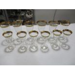 A set of six gold rimmed wine glasses along with six matching sherry glasses