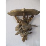 A carved gilded wall bracket decorated with a bird in its nest, height approx. 22cm