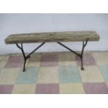 A wooden bench with cast iron base