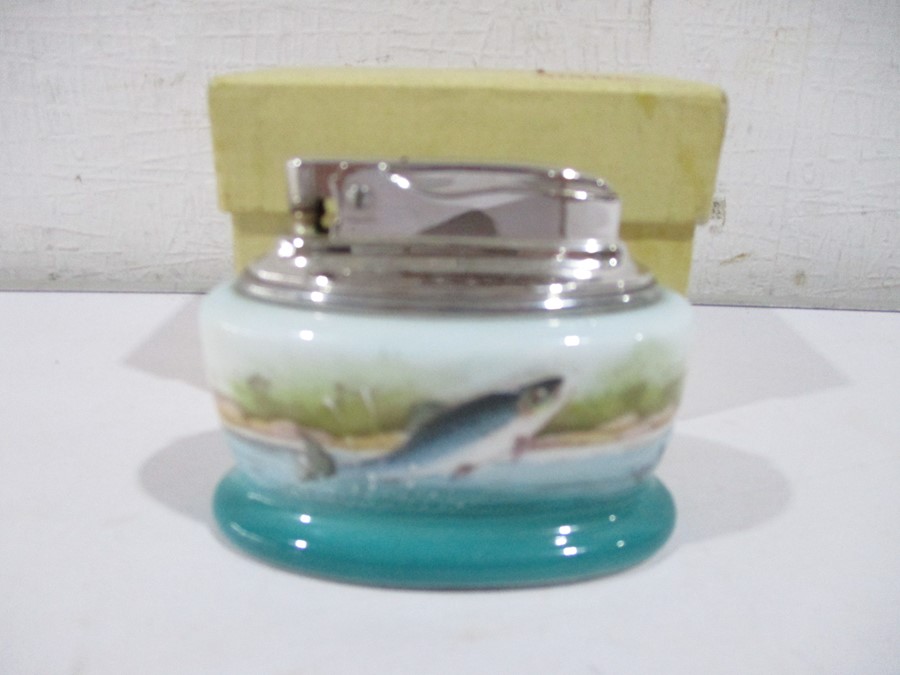 A boxed Minton porcelain cased Ronson table lighter, painted with leaping salmon signed R Scott