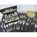 A collection of various silver plated items including cutlery, toast rack sugar tongs etc