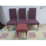 A set of three modern dining chairs, upholstered in a tartan style fabric, along with a footstool.