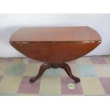 A Victorian dropleaf table on cabriole legs