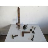 A small collection of tools including level, square and ladle