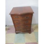 A serpentine chest of four drawers