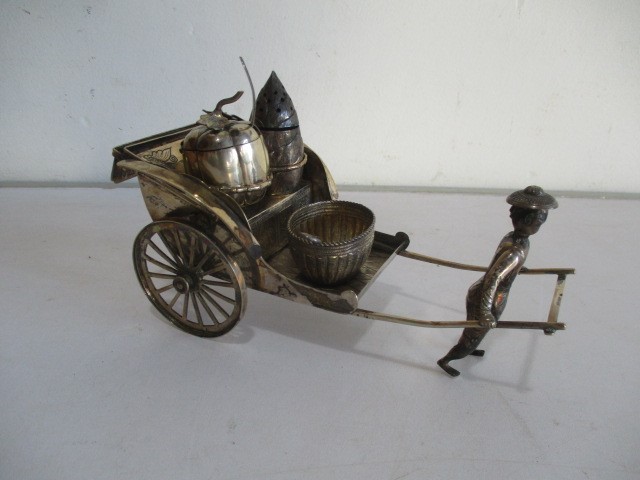 A novelty Chinese silver condiment set in the form of a rickshaw