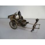 A novelty Chinese silver condiment set in the form of a rickshaw