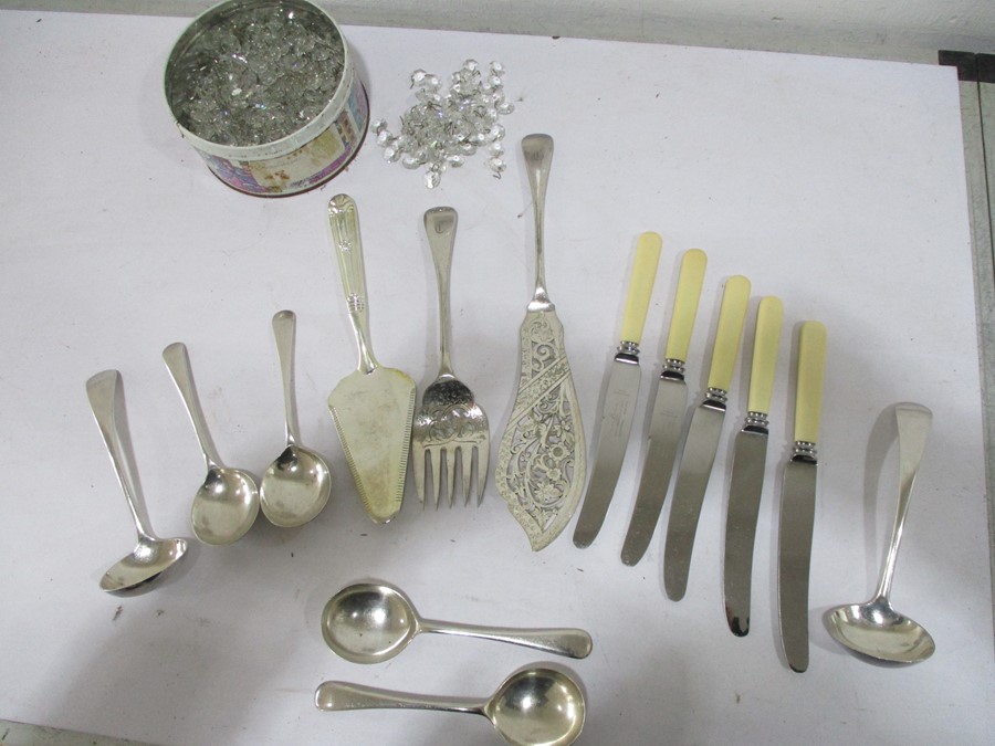 A selection of silver plated cutlery along with a quantity of crystal style drops