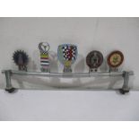 A mounted set of enamelled car badges-The Motor Cycling Club, The Steering Wheel Club, British
