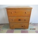 An antique pine chest of three drawers