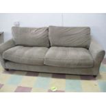 A modern three seater sofa in light grey