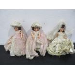 Three vintage dolls one in the style of a bride