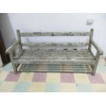 A large weathered wooden garden bench