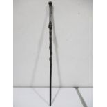 A carved African walking stick with silver coloured banding