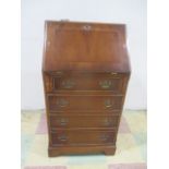 A reproduction narrow bureau with four drawers unit