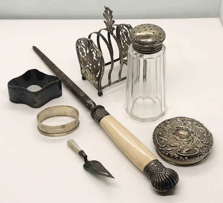 A hallmarked silver bookmark in the form of a trowel, silver lidded sugar caster, silver lid along