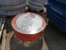 BELLE GLASS TOPPED COFFEE TABLE MADE FROM TRACTOR WHEEL RIM.