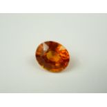 Unmounted oval natural orange sapphire. 9.85ct