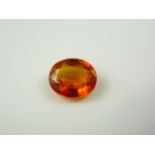 Unmounted oval natural orange sapphire. 8.55ct