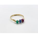 14ct gold spinning emerald, sapphire and ruby ring