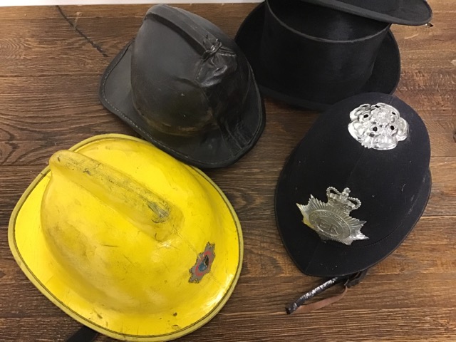 A Metropolitan police helmet together with a 1940s leather fireman's helmet 1980s fibre glass - Image 2 of 2