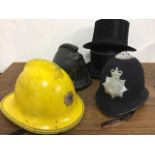 A Metropolitan police helmet together with a 1940s leather fireman's helmet 1980s fibre glass