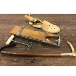 A Riding crop, boot pull and shoe stretchers
