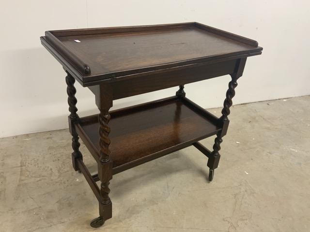 An oak swivel top card table with barley twist legs and lower shelf W:78cm x D:43cm x H:75cm