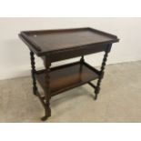 An oak swivel top card table with barley twist legs and lower shelf W:78cm x D:43cm x H:75cm