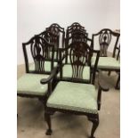 A set of ten modern hard wood upholstered dining chairs. Eight chairs and two carvers.
