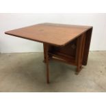 A mid 20th century teak drop leaf dining table. W:83cm x D:146cm x H:71cm(fully extended)