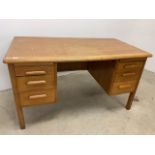 A light oak pedestal desk W:137cm x D:75cm x H:75cm