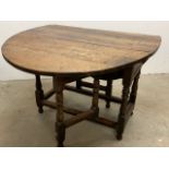 An 18th century oak gateleg table with square stretchers and turned feet W:104cm x D:43cm x H: