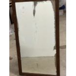 An oak wall mirror with bevelled glass W:90cm x D:cm x H:50cm