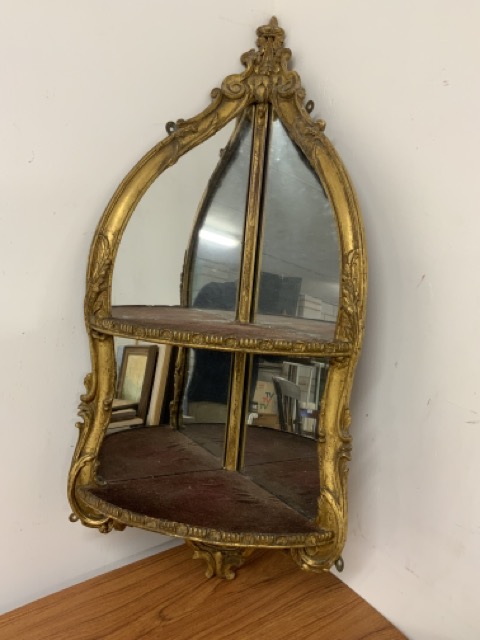 A Georgian gilt corner mirror with shelf decorated with scrolls and shells W:35cm x D:35cm x H: