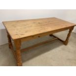 A pine farmhouse table with small drawer to side W:180cm x D:89cm x H:75cm