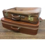 A vintage leather suitcase and another