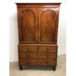 A 19th century mahogany two part linen press on chest. Two cupboard doors with beaded arch.