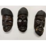Three African carved tribal masks W:20cm x D:10cm x H:46cm