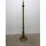 A gilt pedestal floor lamp on carved circular base. W:35cm x D:35cm x H:162cm