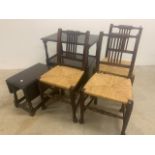 Three wicker seated dining chairs together with a a dark oak drop flap table and a buffet